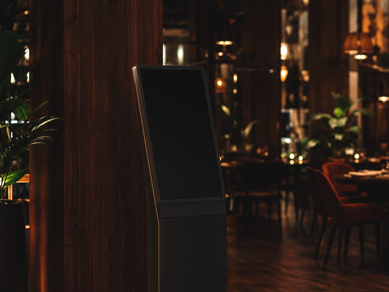 Ordering terminal installed in the dining room of a restaurant at night